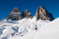 Dolomites covered by snow and sporty people with s