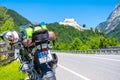 Dolomites Italy - July 2, 2022: Motorcycle with full equipment on the side of a rural mountain alpine road in area of