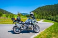 Dolomites Italy - July 2, 2022: Motorcycle with full equipment on the side of a rural mountain alpine road in area of