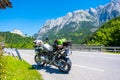 Dolomites Italy - July 2, 2022: Motorcycle with full equipment on the side of a rural mountain alpine road in area of