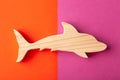 Dolphin figurine carved from solid pine by hand jigsaw. On a multi-colored background