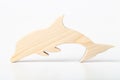 Dolphin figurine carved from solid pine by hand jigsaw. On a white background