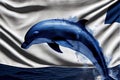 a dolphin jumping out of the water with a flag in the background that is white and blue with a blue border Royalty Free Stock Photo