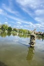 A dolphin sculpture in a small lake of a public park Royalty Free Stock Photo