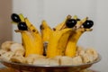 Dolphin shaped fruit plate. Dolphins of banana and grapes Royalty Free Stock Photo