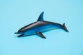 Dolphin toy on blue background. Royalty Free Stock Photo