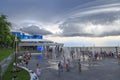 At dolphinarium in Odessa, Ukraine - August 6, 2019 : People having fun at fountain near the dolphinarium with rain clouds in