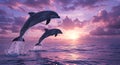 Dolphins leaping from the ocean against a dramatic sky at sunset. The water spl Royalty Free Stock Photo