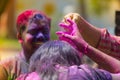 A woman smeared with colored powder, takes part in celebrations of the Dol Utsav Festival, a festival of the Hindu community, at