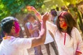 People covered in colorful powder dyes celebrating the Holi Hindu Festival in Dhakah in Bangladesh.