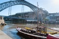 The Dom Luis I Bridge over the Douro River with Rabelo boats. Porto, Portugal Royalty Free Stock Photo