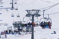 Dombai, Russia-December 7, 2017: skiers and snowboarders lift to the Ski Resort high in the winter snow mountains at Royalty Free Stock Photo