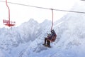 DOMBAI, RUSSIA - JANUARY 3, 2014: People are lifting on open lft high up in Caucasus mountains