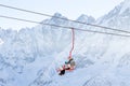 DOMBAI, RUSSIA - JANUARY 3, 2014: People are lifting on open lft high up in Caucasus mountains