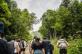 Dombay, Russia 26 July 2020: Group of people go hiking in wooded and hilly area. Rear view of tourists walking on rocky