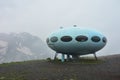 Dombay, Russia - June 09, 2022: hotel is in the form of a flying saucer on the mountain, flying saucer in the mountains, UFO in