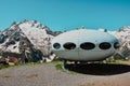 Dombay, Russia - June 11, 2022: hotel is in the form of a flying saucer on the mountain, flying saucer in the mountains, UFO in