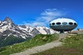 Dombay, Russia - June 11, 2022: hotel is in the form of a flying saucer on the mountain, flying saucer in the mountains, UFO in