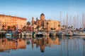 Saint Raphael, France - June 18th 2018: A waterfront scene showing the basilica overlooking shops, restaurants and the marina.