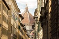 The dome of Cathedral of Santa Maria del Fiore, view from the narrow streets of Florence, Italy