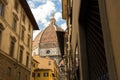 The dome of Cathedral of Santa Maria del Fiore, view from the narrow streets of Florence, Italy