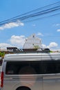 dome of church of santa cruz del quiche with clouds in the sky with parked bus