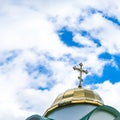 Dome with a golden cross orthodox church. Blue sky with white clouds. Royalty Free Stock Photo