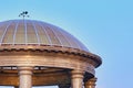 Dome of a marble rotunda made of transparent glass. Sunlight at dawn. Details of architecture on the embankment of the