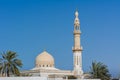 The dome and minaret of Maharba mosque and palm tree against blue sky in Dubai, United Arab Emirates Royalty Free Stock Photo