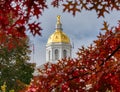 Dome of the New Hampshire state capitol building with red autumn leaves in the foreground Royalty Free Stock Photo