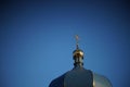 Dome of the Orthodox Church and a golden cross against a blue clear sky Royalty Free Stock Photo