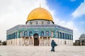 The Dome of the Rock and a Mosque in the Old City of Jerusalem with a one young Arabian women passing in front, Israel. Royalty Free Stock Photo