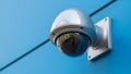 Dome security camera mounted on blue wall Royalty Free Stock Photo