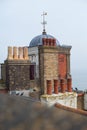 The dome and weather vane of Wellington Crescent Cliff Lift, an Edwardian grade II listed working lift behind impressive rooftops