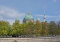 Domes of Berlin cathedral and television tower above trees, Berlin