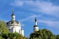 The domes of the Christian church against the blue sky and green trees Royalty Free Stock Photo