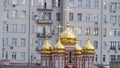 The domes of the church on the background of a residential building in Moscow.