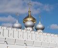 Domes of the Smolensk Cathedral on the white defensive wall of the Novodevichy Convent against the background of blue sky, Moscow Royalty Free Stock Photo