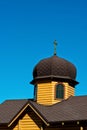 Domes of a wooden church on a blue sky background. Royalty Free Stock Photo