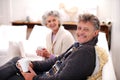 Domestic bliss is their reality. Portrait of a senior couple relaxing in their living room with coffee.