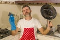 Domestic chores stress - young attractive overworked and stressed home cook man in red apron hating dishwashing feeling upset and Royalty Free Stock Photo