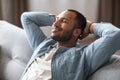 Domestic Comfort. Relaxed Young Black Man Leaning Back On Couch At Home Royalty Free Stock Photo