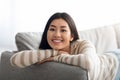 Domestic Comfort. Young Smiling Korean Lady Resting On Couch In Living Room Royalty Free Stock Photo