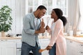 Domestic Concert. Funny Black Spouses Fooling In Kitchen, Singing With Utensils Royalty Free Stock Photo