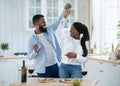 Domestic Date. Cheerful Black Lovers Dancing In Kitchen, Having Fun At Home Royalty Free Stock Photo