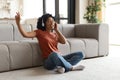 Domestic Fun. Cheerful African Woman Listening Music In Wireless Headphones At Home Royalty Free Stock Photo