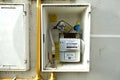 Domestic gas meter in a box set into the wall of a house. Royalty Free Stock Photo