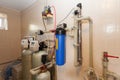 A domestic household boiler room with a new modern solid fuel boiler , heating electric warm water system and pipes.