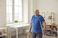 Senior person with broken leg or physical disability walking with crutches at home