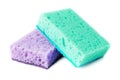 Domestic needs. A mint-colored sponge lies on a purple sponge at a slight angle. isolate